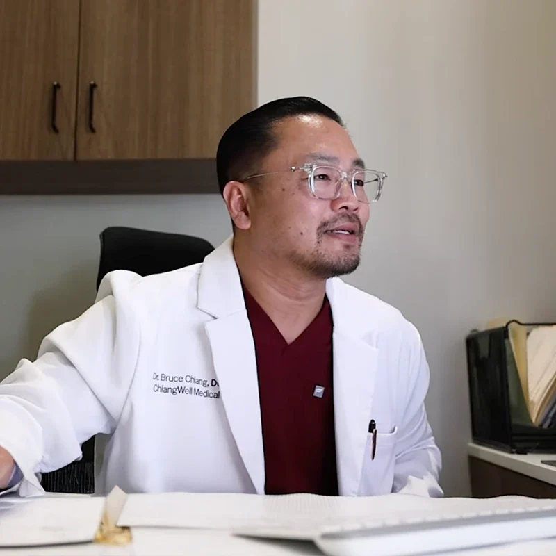 Chiropractor Plantation FL Bruce Chiang At His Desk